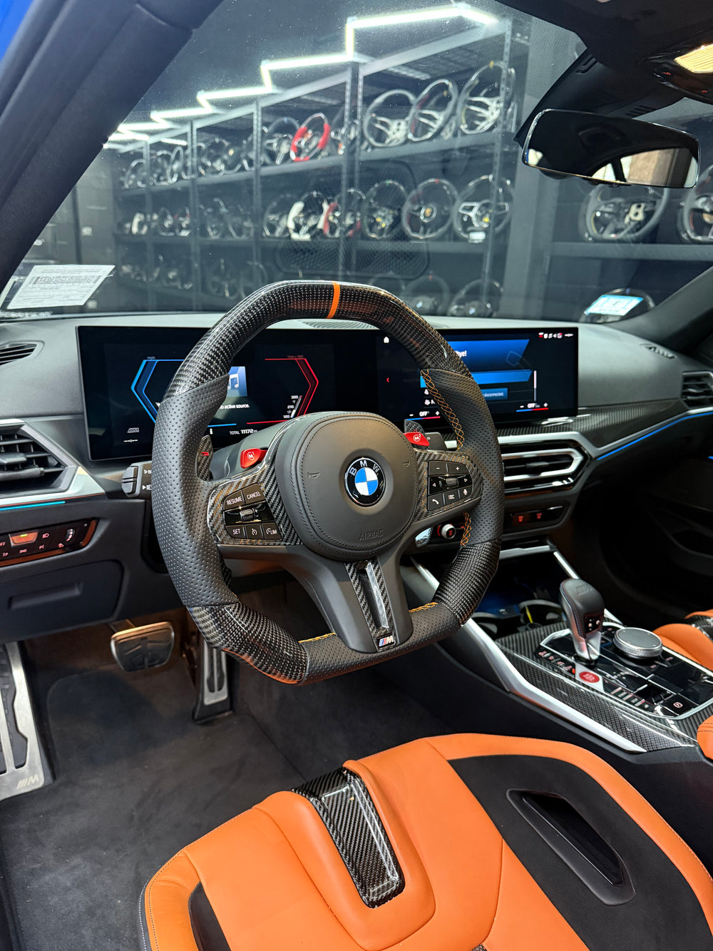 [Made to Order] BMW G-Series (M Performance Wheel) - Signature - Matte Carbon - Perforated Leather - Orange Stitching - Orange Stripe