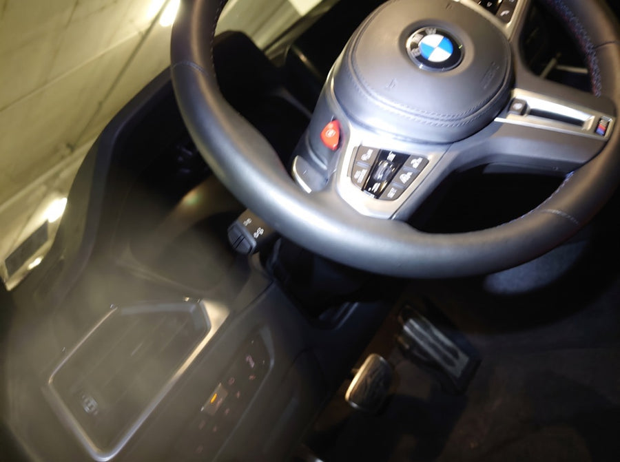 Illustration of a bad photo: dark, blurry, cropped steering wheel