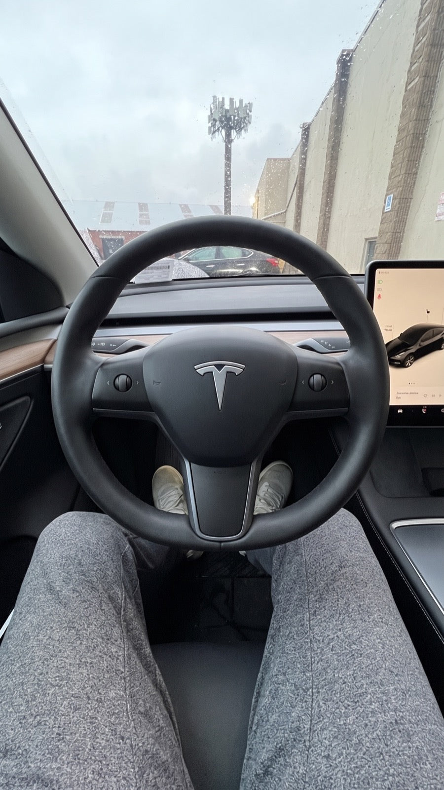 Tesla Model 3 cabin with the factory steering wheel