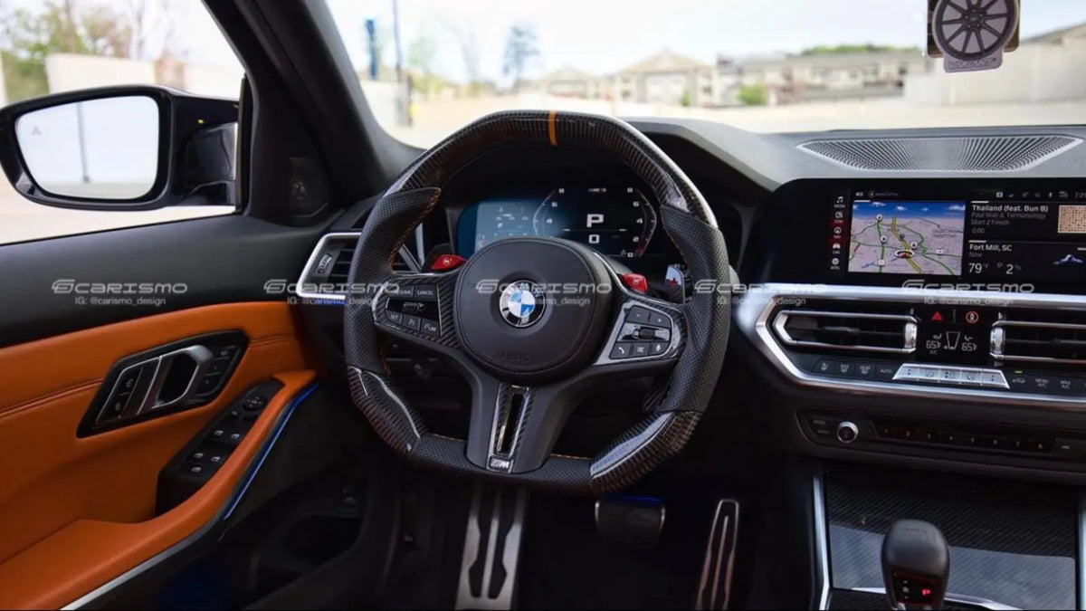 Carismo carbon fiber and perforated leather steering wheel installed in a BMW M3