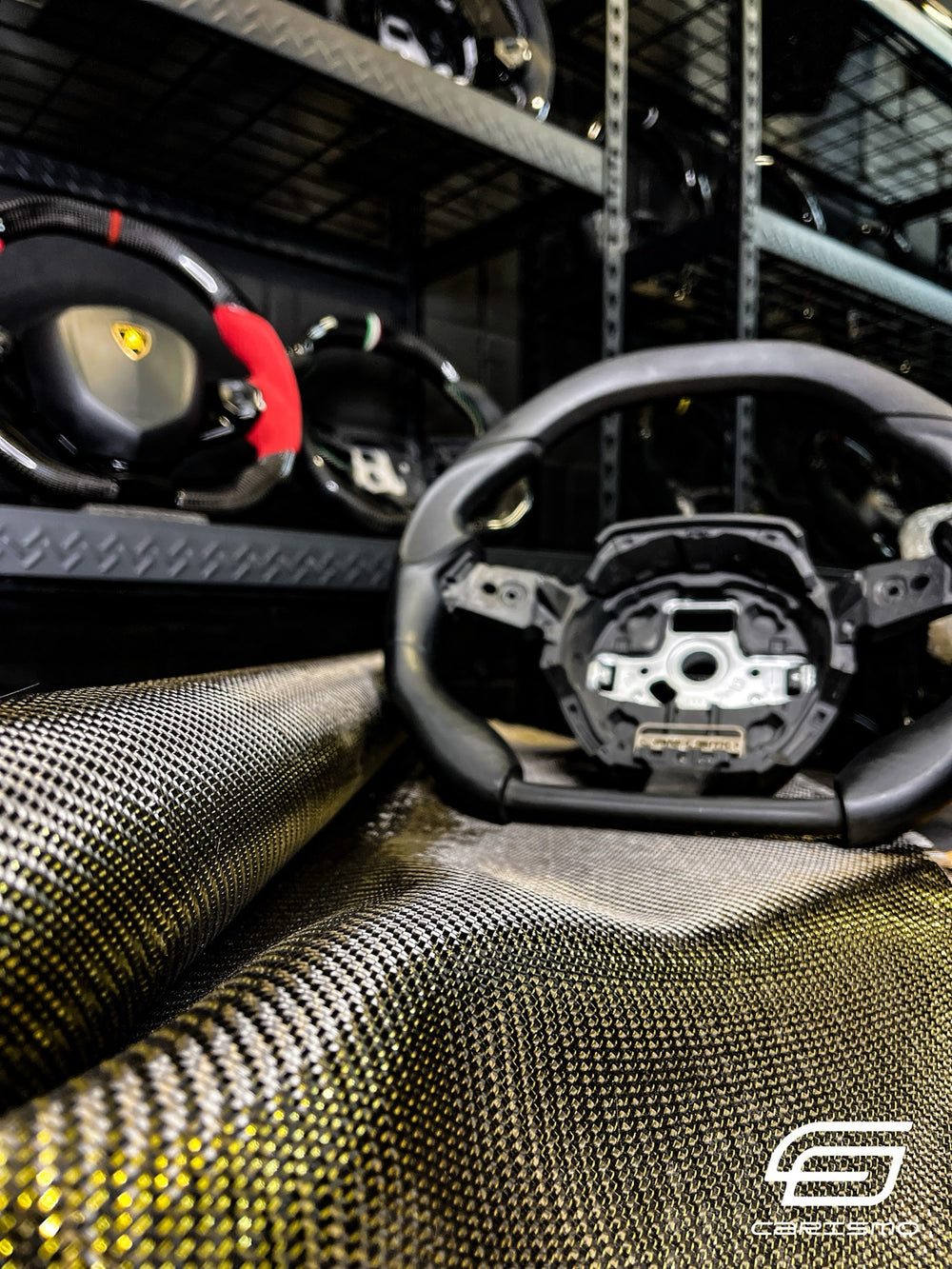 Carbon fiber fabric in front of the wheel shelves in the Carismo workshop