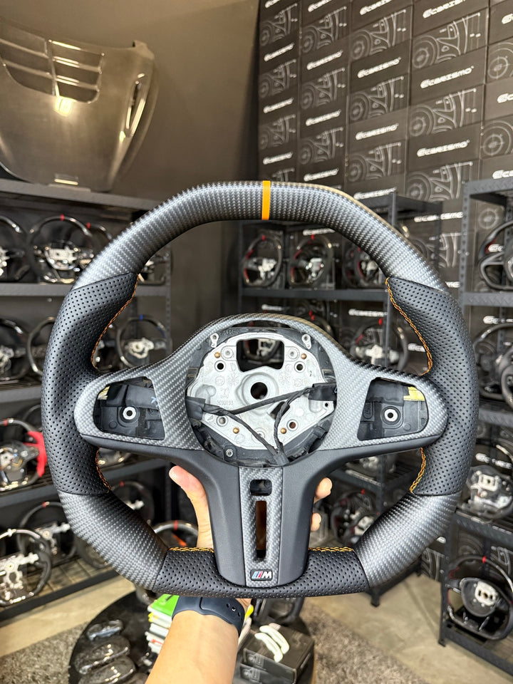 [Made to Order] BMW G-Series (M Performance Wheel) - Signature - Matte Carbon - Perforated Leather - Orange Stitching - Orange Stripe