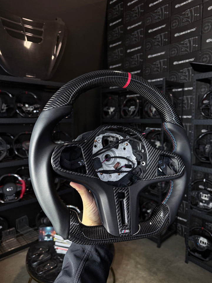 [Made to Order] BMW G-Series (M Performance Wheel) - Sport - Gloss Carbon - Smooth Leather - BMW M Colors Stitching - Red Stripe