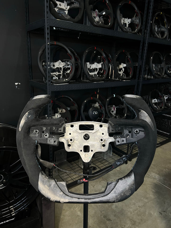 [Made to Order] GMC Sierra (Gen 5) - F1 Competition - Matte Forged Carbon - Alcantara with Forged Carbon Thumb Grip - Light Blue Stitching - No Stripe