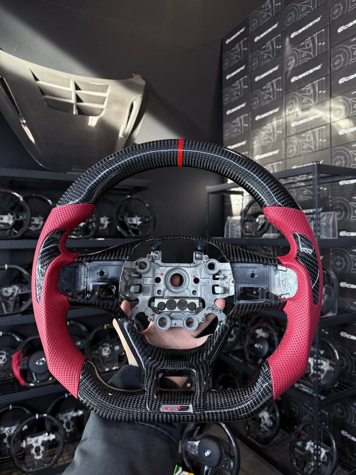 [Made to Order] Kia K5 (Gen 5) - Sport - Gloss Carbon - Red Perforated Leather with Carbon Thumb Grip - Black Stitching - Red Stripe
