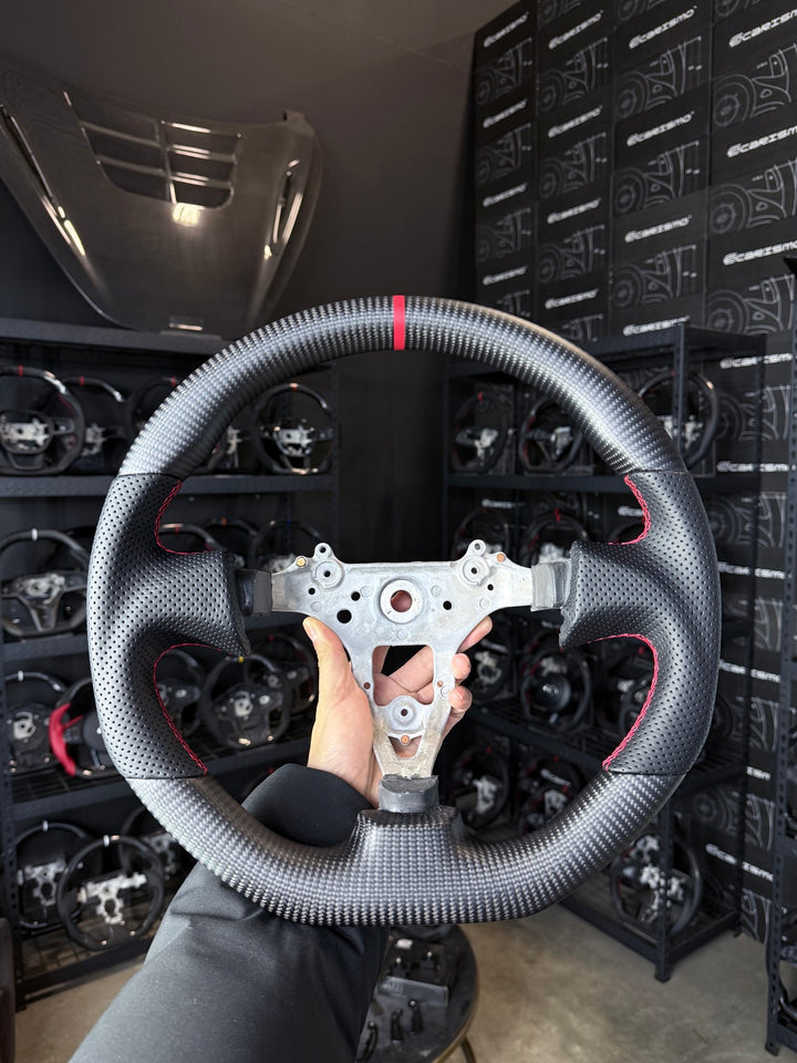 [Made to Order] Nissan GT-R (R34) - Sport - Matte Carbon - Perforated Leather - Red Stitching - Red Stripe