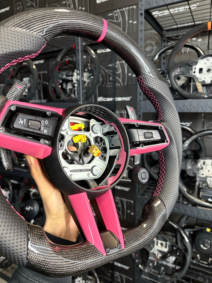[Made to Order] Porsche (992.1 Wheel) - Sport - Gloss Plain Carbon - Perforated Leather - Pink Stitching - Pink Stripe